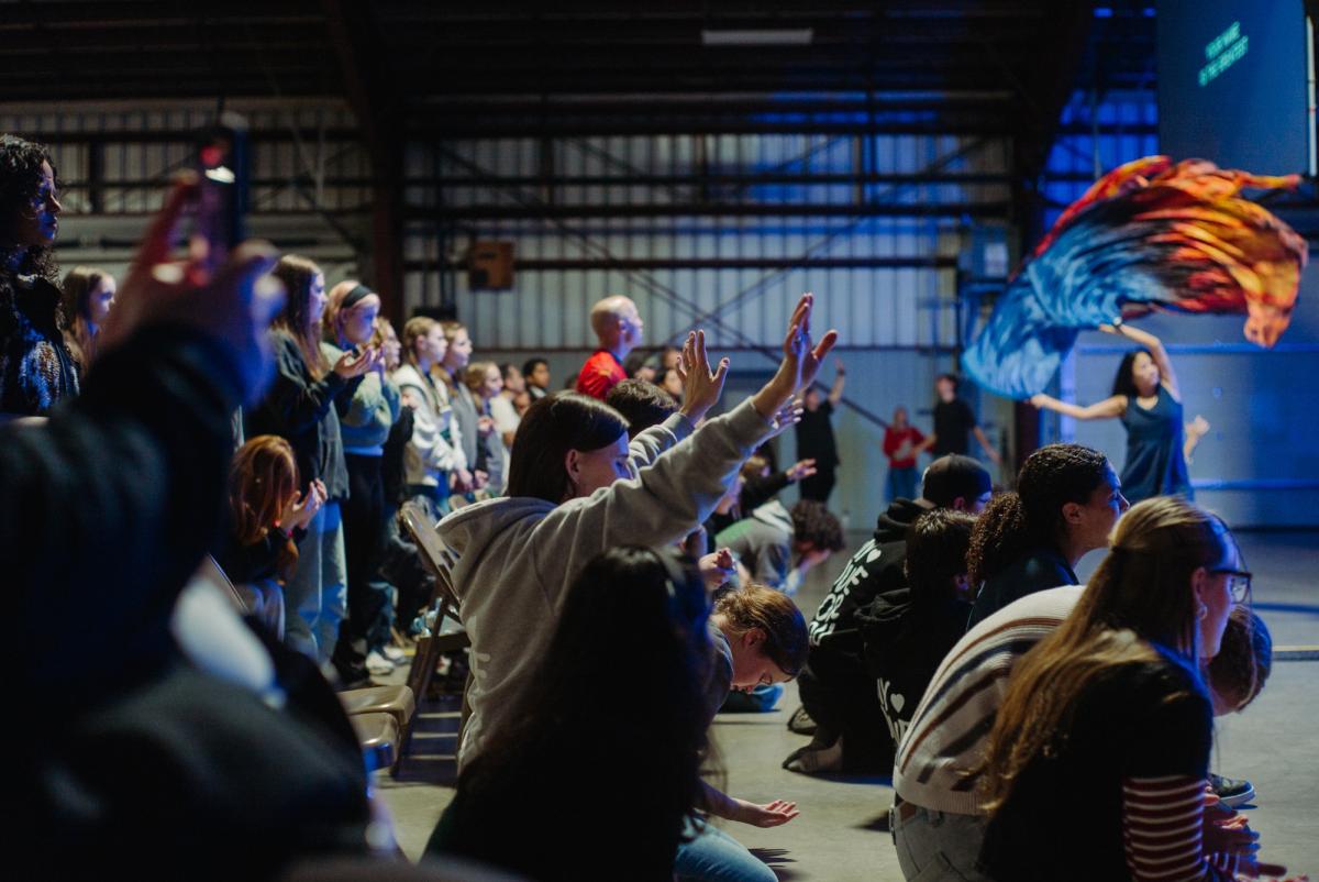 Youth worshiping during a General Session